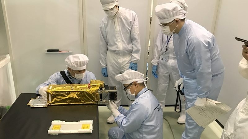 Japanese engineers are preparing the NanoDragon satellite for launch. 