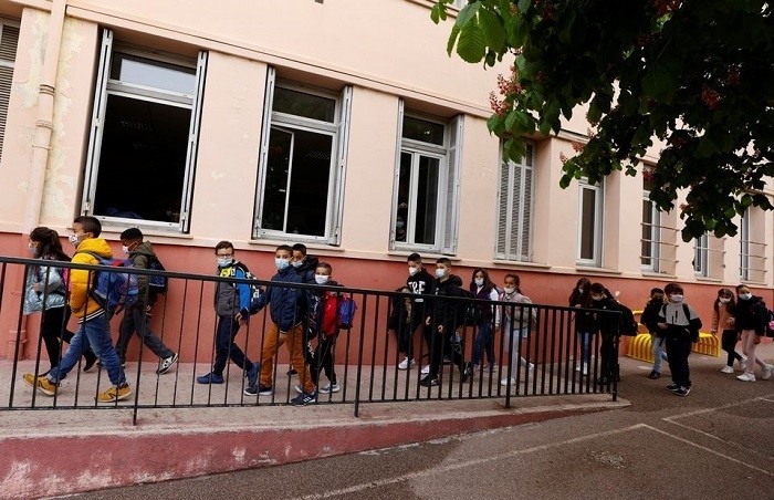 Twelve million French children headed back to school on Thursday, wearing facemasks, using sanitizer at the entrance and standing distanced from each other in the yard under strict government rules aimed at curbing the spread of COVID-19.