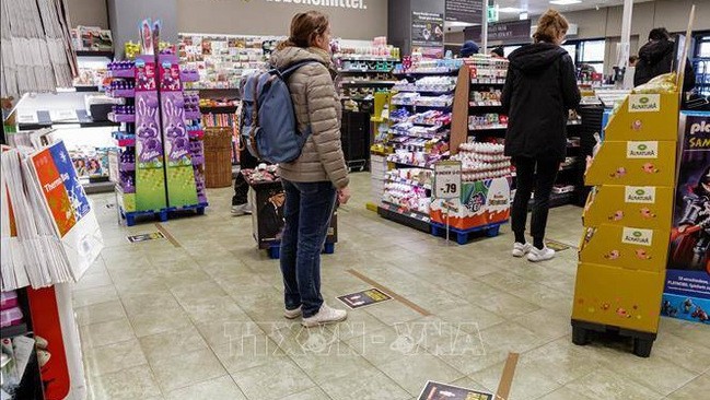 People implement social distancing in a supermarket in Berlin, Germany. (Photo: xinhua/VNA)