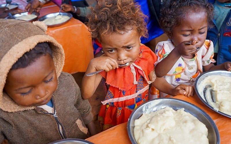 Children in Madagascar receive food aid.