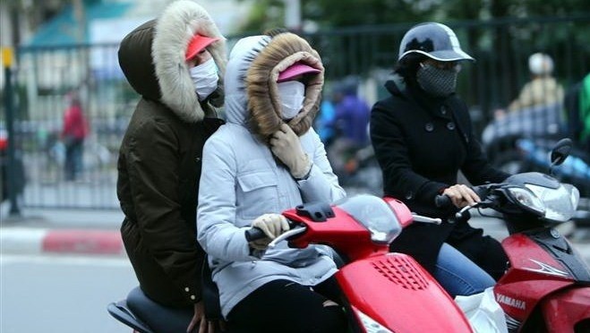 Hanoians wear thick clothes in the cold weather. (Photo: VNA)