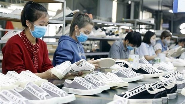 Workers produce footwear for export to the EU at a factory of the Ha Tay Chemical Weave Co. Ltd in Hanoi's Dan Phuong district (Photo: VNA)
