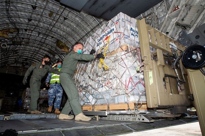 Australian Defence Forces members unload humanitarian assistance and engineering equipment from an aircraft at Fua'amotu International Airport, Tonga, January 20, 2022. (Source: Australian Department Of Defence/Handout via Reuters)