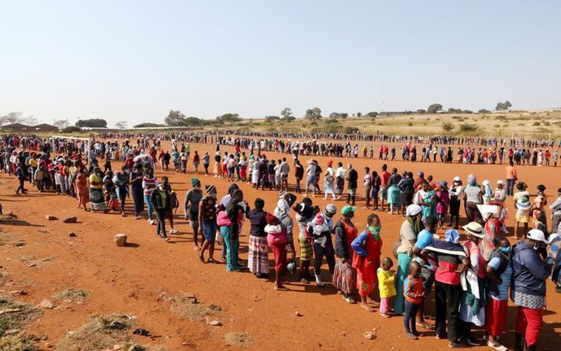 Lines of people waiting to receive food in South Africa. (Photo: Reuters)