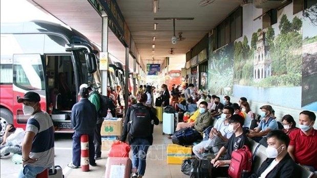 A bus station in HCM City is crowded with people waiting for coaches to return to their hometowns for Tet holidays. (Photo: VNA)