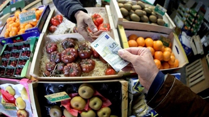 A shopper pays with a Euro bank note in a market in Nice, France. (Photo: Reuters)