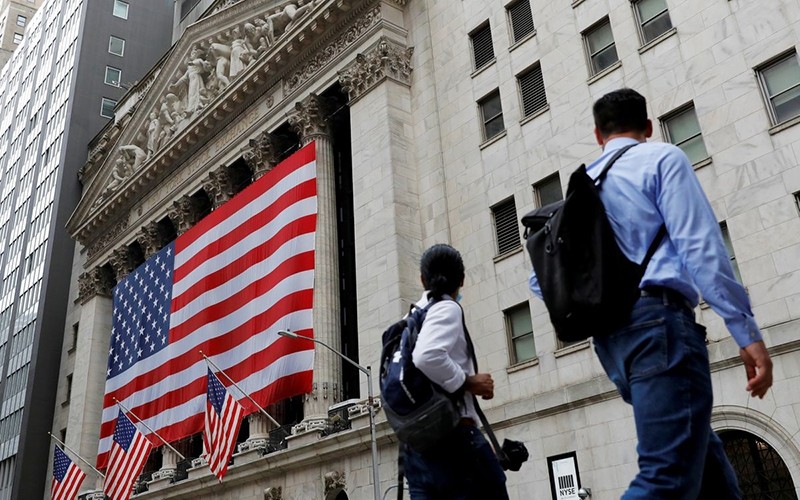 People walk in front of the New York Stock Exchange (NYSE). (Photo: Reuters)