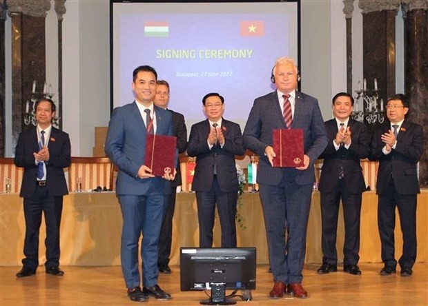 National Assembly Chairman Vuong Dinh Hue (centre) witnesses the signing of the MoU between universities of Vietnam and Hungary. (Photo: VNA)