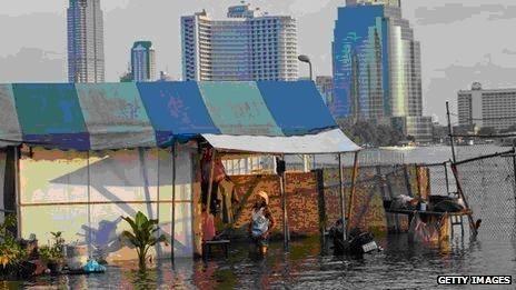 The Chao Phraya river, which bisects Bangkok, is swollen by floods and high tides.