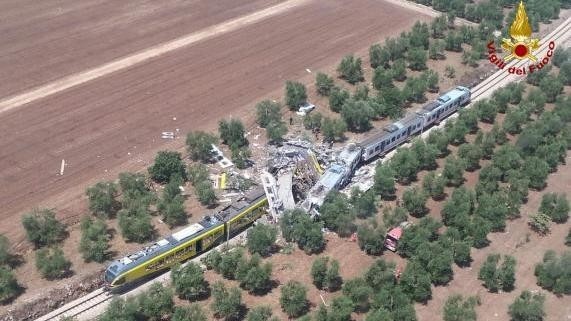 Two passenger trains are seen after a collision in the middle of an olive grove in the southern village of Corato, near Bari, Italy. (Credit: Italian Firefighters/Handout via Reuters)