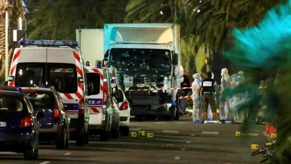 French police forces and forensic officers stand next to a truck July 15, 2016 that ran into a crowd celebrating the Bastille Day national holiday on the Promenade des Anglais killing at least 60 people in Nice, France, July 14. (Credit: Reuters)