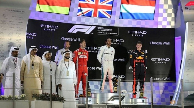 Mercedes' Lewis Hamilton celebrates on the podium after winning the race with second place Ferrari's Sebastian Vettel and third place Red Bull's Max Verstappen. (Reuters)