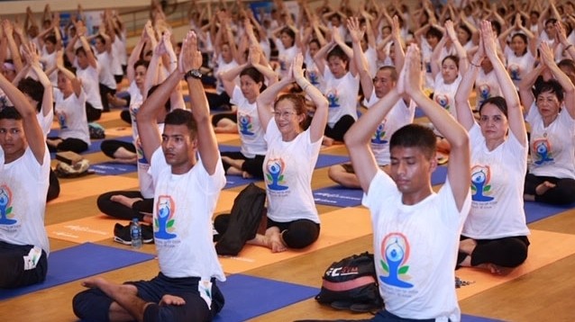 Nearly 1,000 people practice yoga together to mark the International Day of Yoga