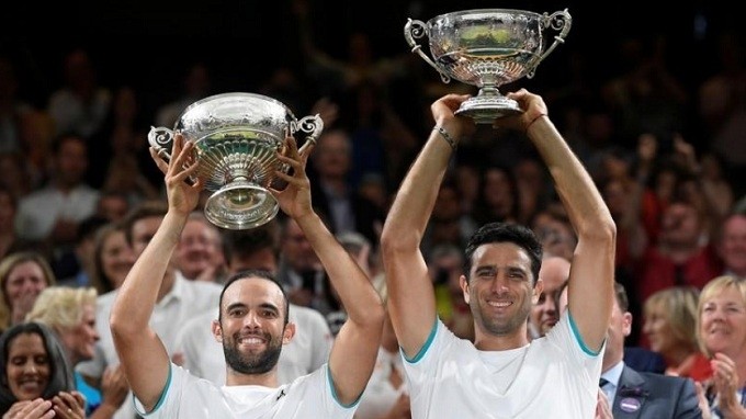 Tennis - Wimbledon - All England Lawn Tennis and Croquet Club, London, Britain - July 13, 2019 Colombia's Juan-Sebastian Cabal and Robert Farah celebrate winning the men's doubles final with the trophies against France's Nicolas Mahut and Edouard Roger-Vasselin. (Reuters)