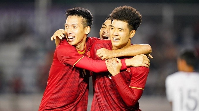 Ha Duc Chinh (R) celebrates with teammate Do Hung Dung after completing his double. 