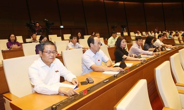 NA deputies press buttons to adopt a law. (Photo: VNA)