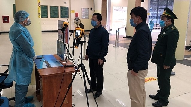 Representatives from the Steering Committee for nCoV prevention in Quang Ninh Province check the remote body temperature monitoring and measurement equipment at Mong Cai International Border Gate. (Photo: NDO)
