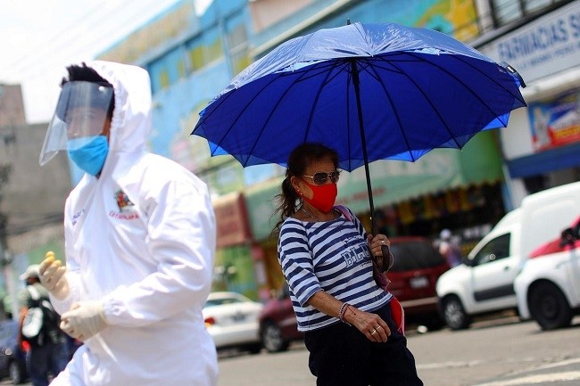 A woman wearing a protective face mask walks on a street in Iztapalapa neighborhood, as the outbreak of the coronavirus disease (COVID-19) continues, in Mexico City, Mexico May 8, 2020. (Photo: Reuters)