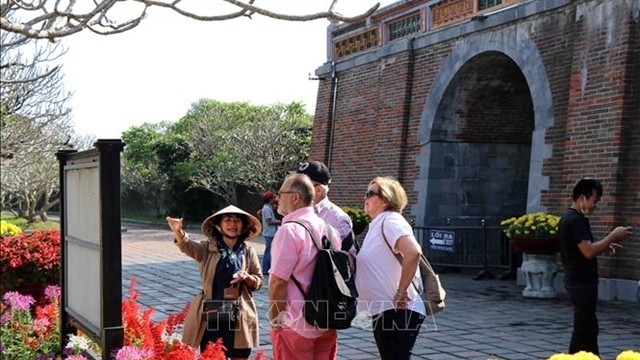 Foreign tourists visit the Imperial Citadel in Hue city in February, before the COVID-19 pandemic forced the country to close its borders. (Photo: VNA)