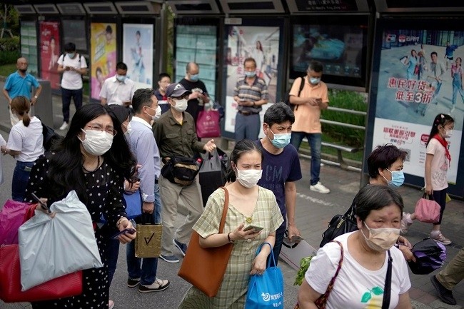   People wearing protective face masks are seen on a street following an outbreak of the novel coronavirus disease (COVID-19), in Shanghai, China May 28, 2020. (Photo: Reuters)
