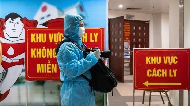 A reporter works in a quarantine area of the National Institute of Hematology and Blood Transfusion. (Photo: VNA)